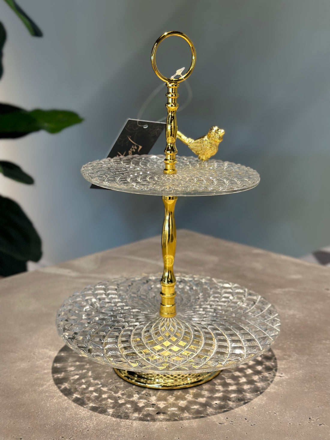 Two-Tier Glass Serving Stand with Gold Handle and Bird Accent